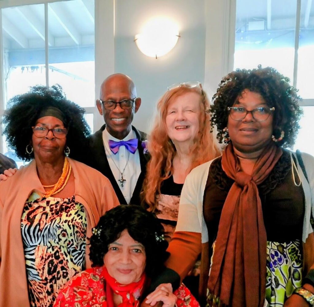 Group of people smiling at a gathering.